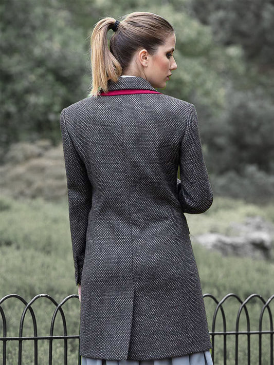 Back view of luxury wool coat showing tailored fit and horn buttons