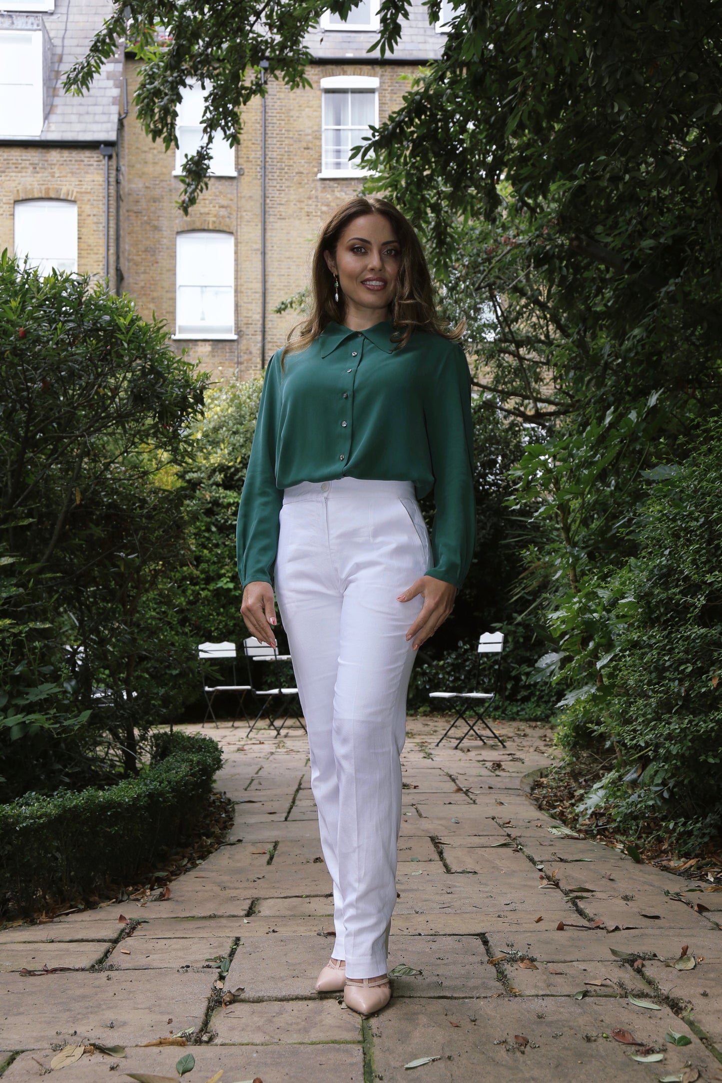 Handcrafted green silk blouse by Moda de la Maria, featuring pearl shell buttons, mid-pointed collar, and hand-finished pleats, sustainable luxury womenswear made in England.