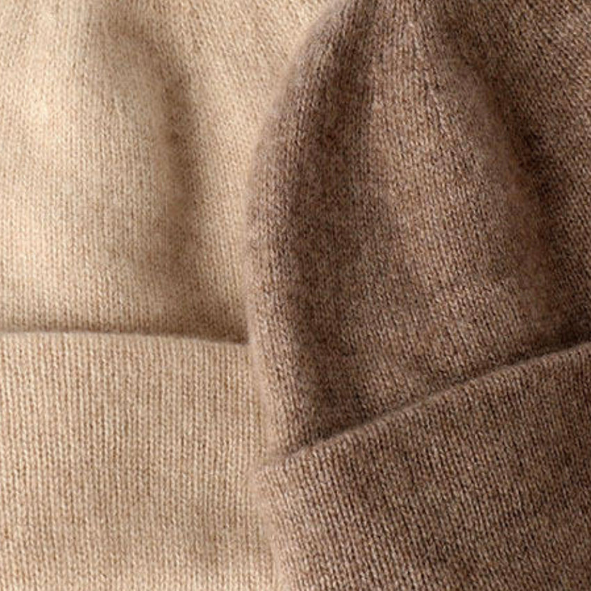 Close-up of a luxury women's pure cashmere beanie showcasing the fine knitted texture, exceptional softness and refined craftsmanship.