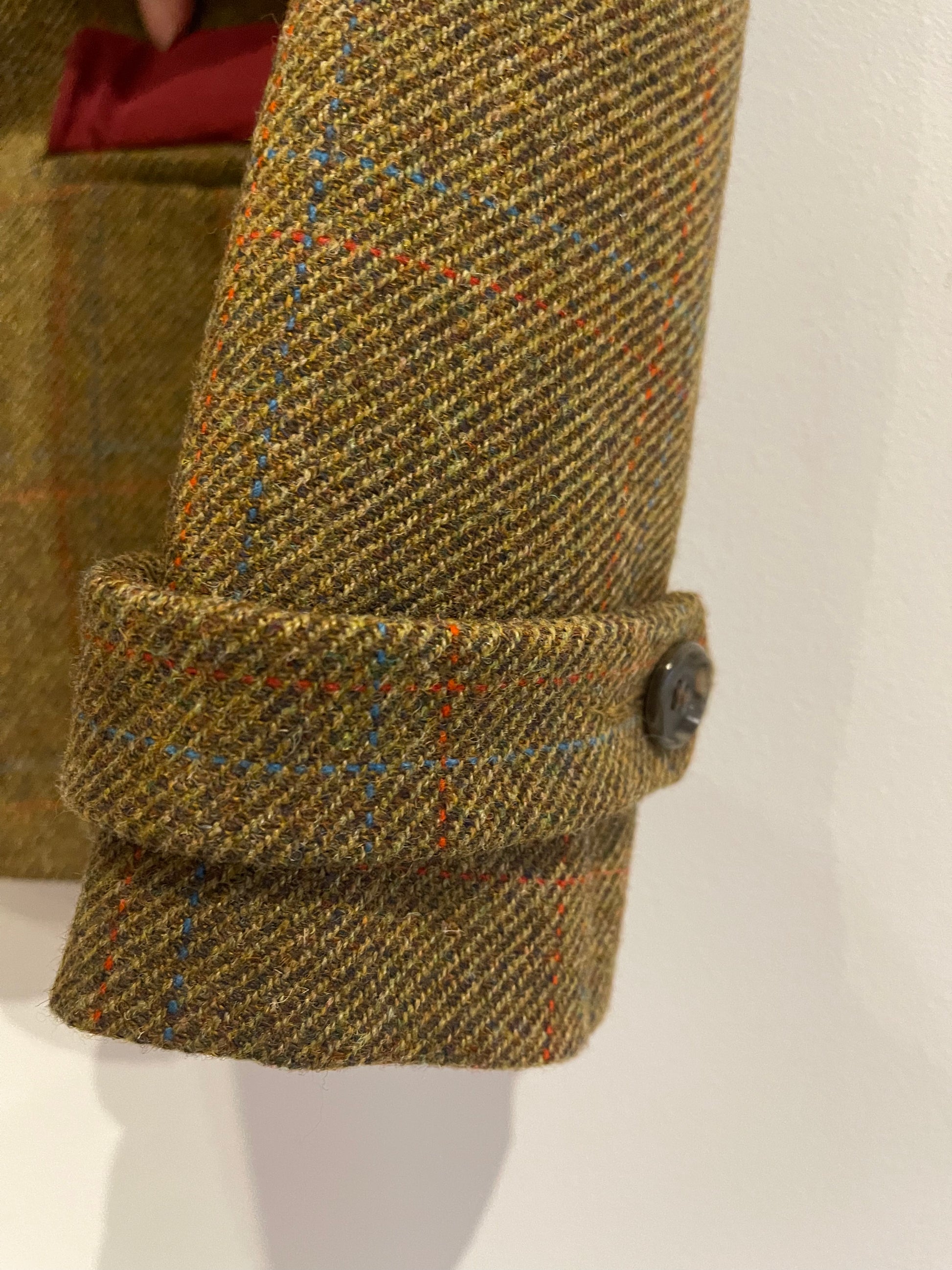 Classic tweed wool jacket with tailored back design, crafted in London.