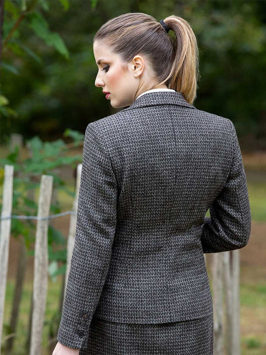 Tailored brown tweed jacket with vented back and horn button details, sustainable slow fashion.