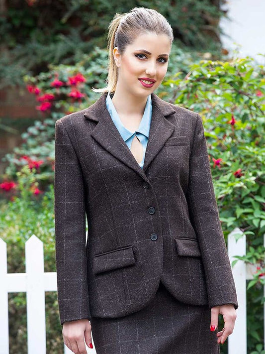 Model wearing brown tweed wool jacket with saffron silk lining, single-breasted cut and horn buttons.
