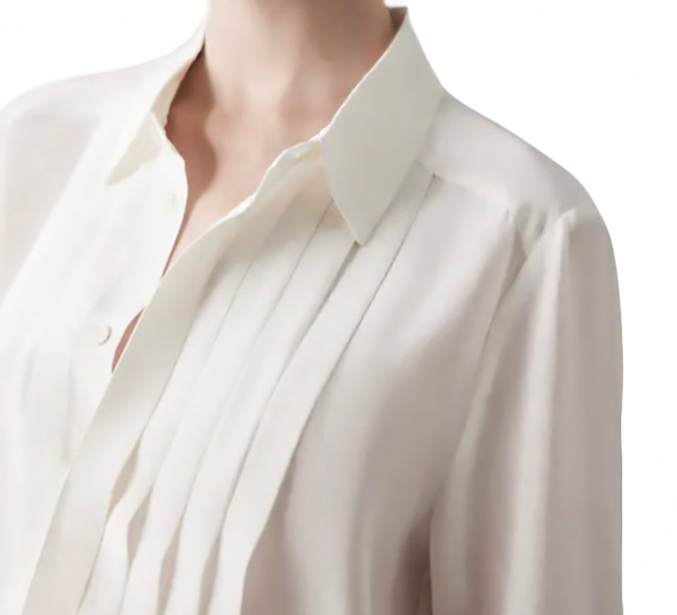 White silk blouse displayed neatly, showcasing minimalist design and versatile styling.