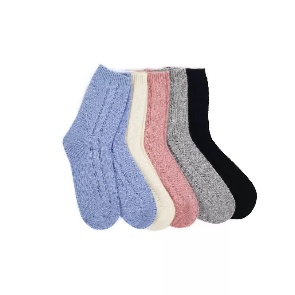 All colourways of pure cashmere cable-knit ankle socks by Moda de la Maria, luxury women’s socks in a grouped flat-lay.