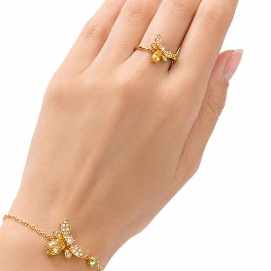 Citrine and peridot bee ring worn on hand showing the scale and open adjustable design