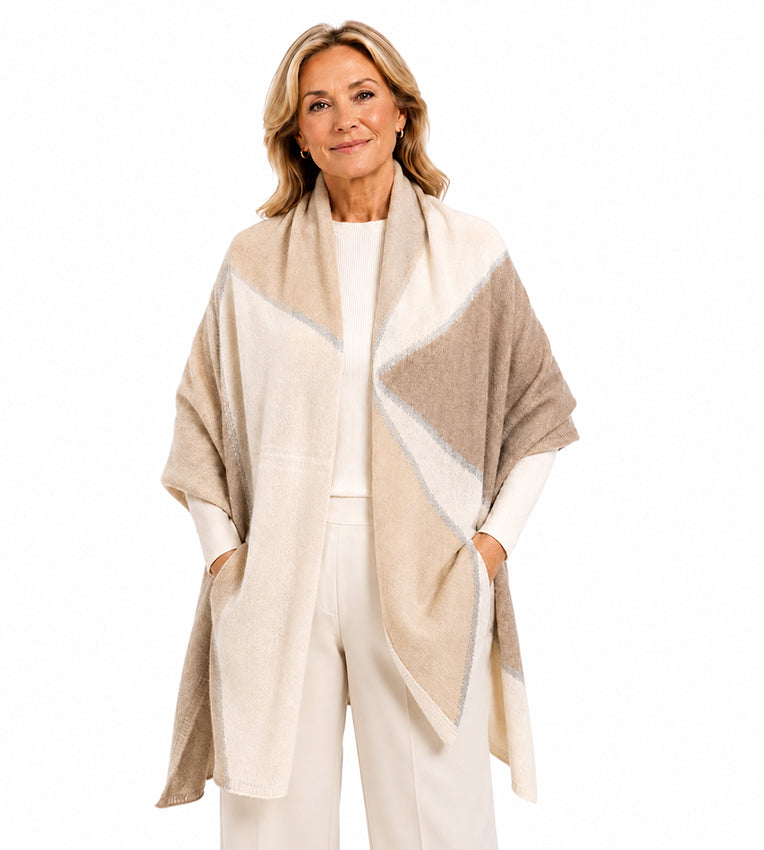 Elegant woman wearing Moda de la Maria 100% pure cashmere colour-block pashmina wrap in beige and cream on a white background.