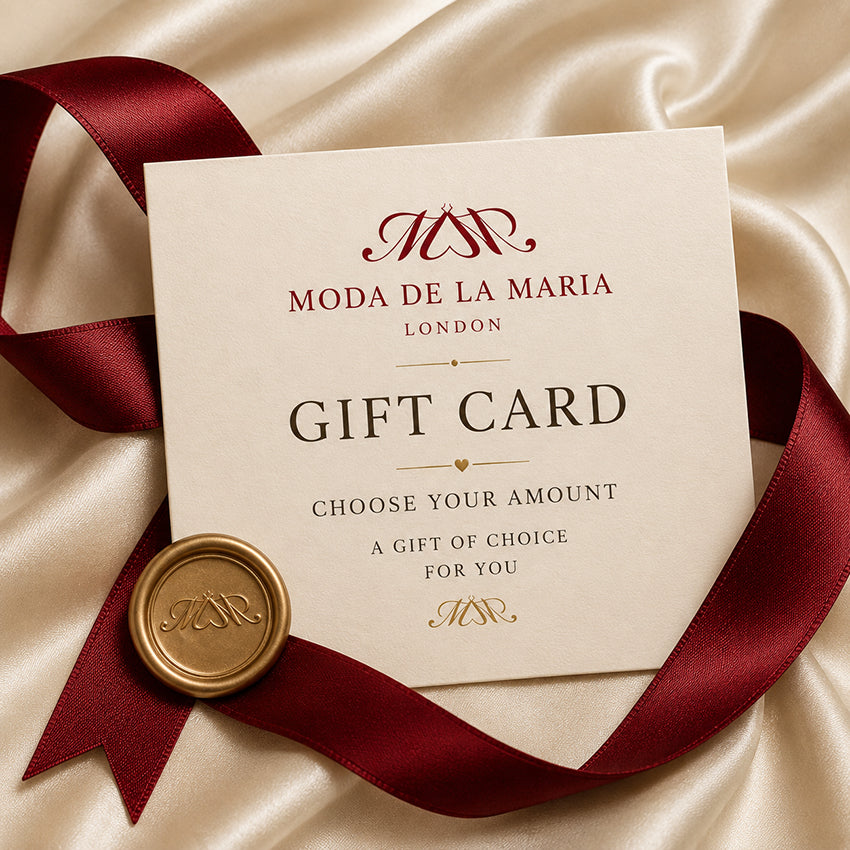 Moda de la Maria luxury fashion gift card with burgundy ribbon on ivory silk, redeemable on womenswear, cashmere, accessories and jewellery.