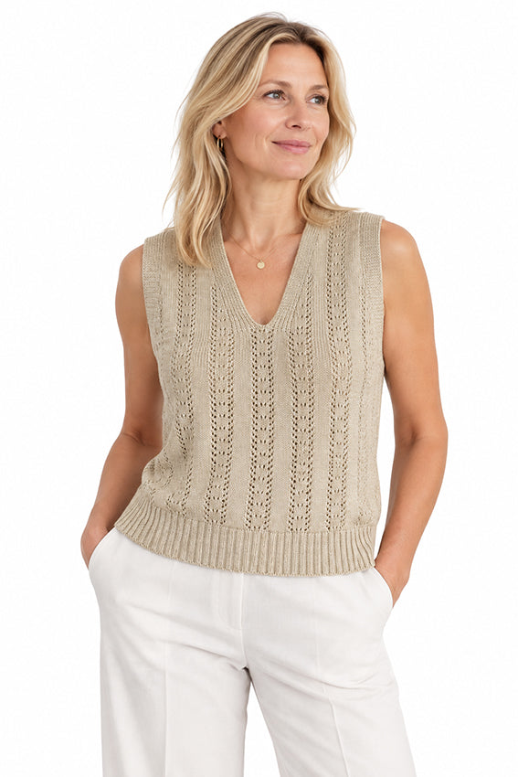 Woman wearing a luxury cashmere V-neck knitted vest with delicate openwork detailing in natural beige