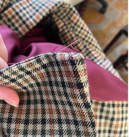 Maria Ruseva sewing a silk lining into a handcrafted jacket