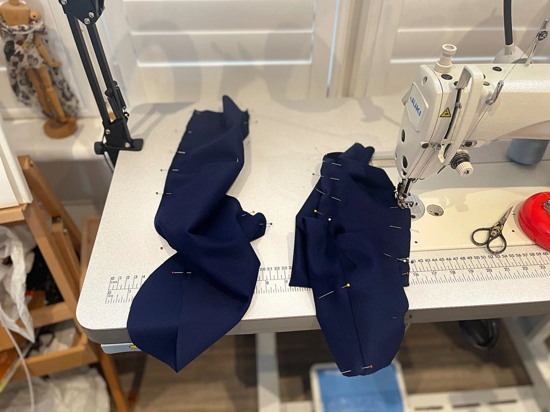 JUKI industrial sewing machine with hand-cut fabric pattern pieces prepared for stitching in the Moda de la Maria atelier, showcasing slow fashion craftsmanship and garment construction.
