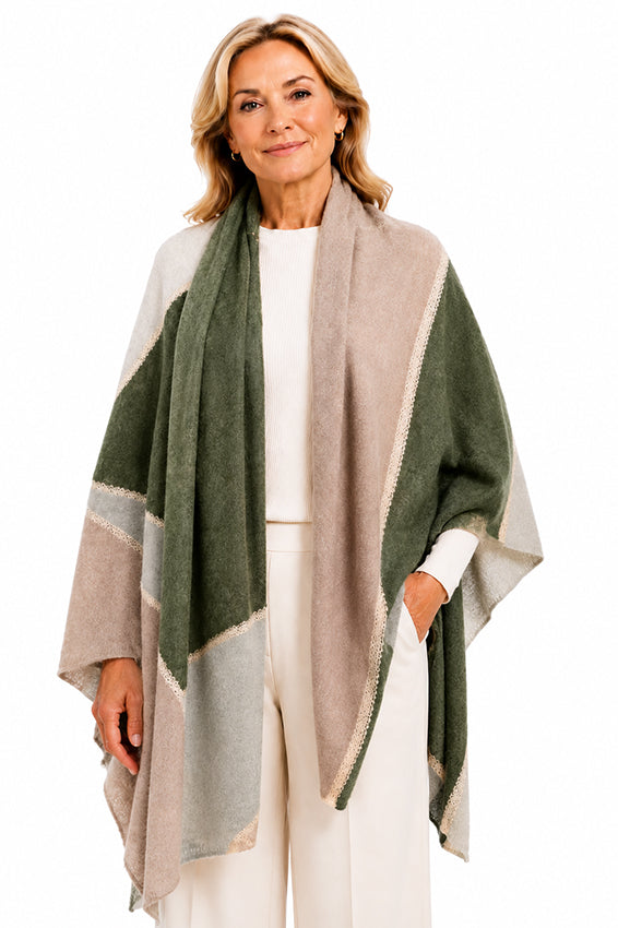 Elegant woman wearing a Moda de la Maria 100% pure cashmere colour-block pashmina scarf in sage green, taupe and cream on a pure white background.