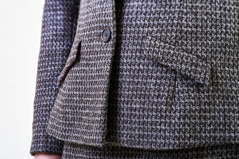 Close-up of brown tweed jacket front flap pocket with horn button, handcrafted in London from Isle of Mull wool.