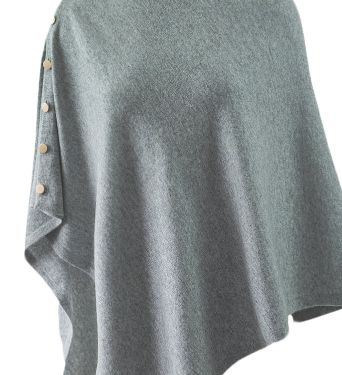 Product-only image of cashmere poncho shawl laid flat, showing button placements and convertible design.