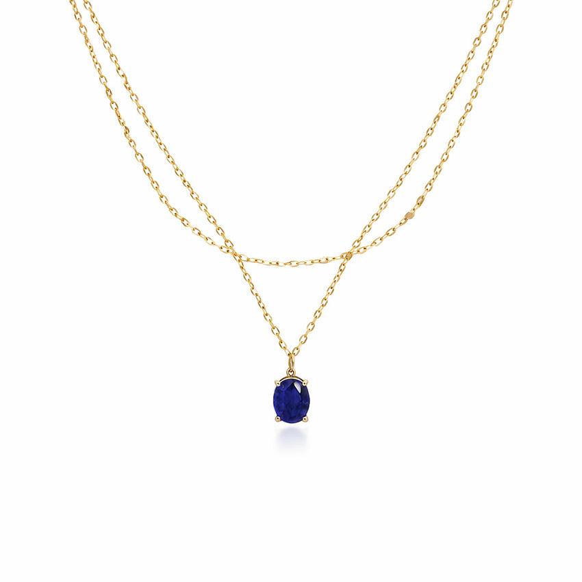 Double layer gold plated sterling silver necklace with oval blue sapphire pendant on white background
