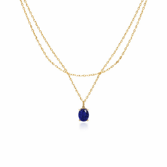 Double layer gold plated sterling silver necklace with oval blue sapphire pendant on white background