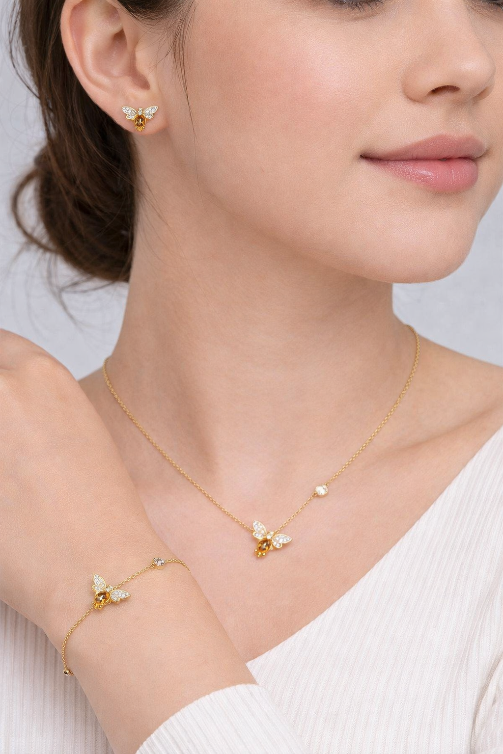 Close-up of bee charm bracelet in gold plated sterling silver with natural citrine stone