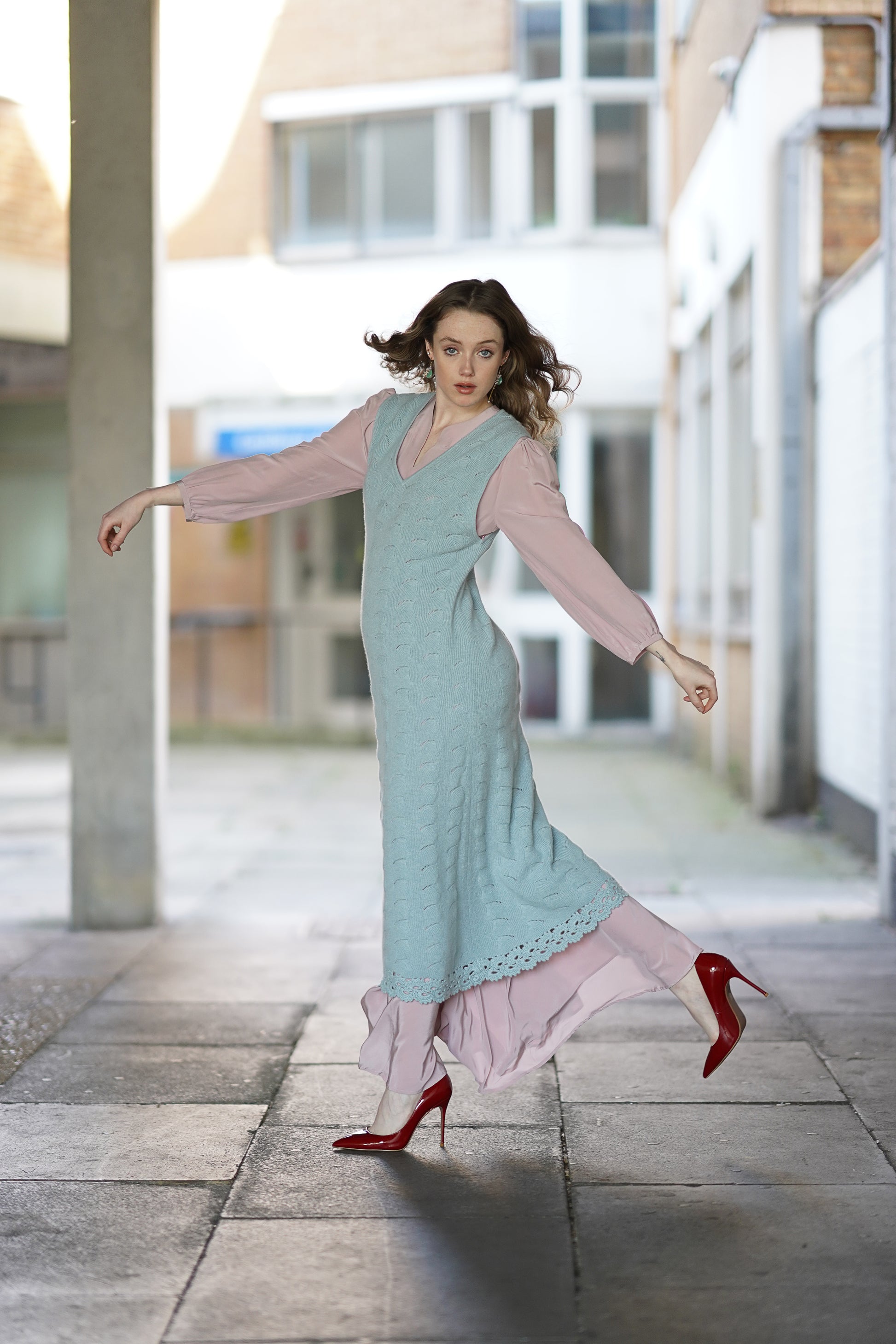 Model layering a blue cashmere dress over a long silk dress, elegant styling by Moda de la Maria showcasing versatile wear.
