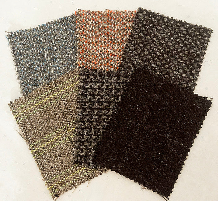 Close-up of luxury tweed wool fabric in grey with subtle green stripe, Moda de la Maria.