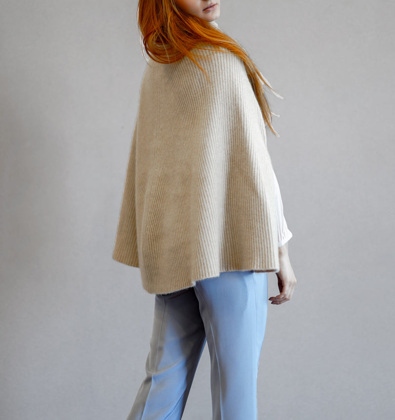 Close-up of organic cashmere knit texture, showing soft and breathable fine-gauge weave.