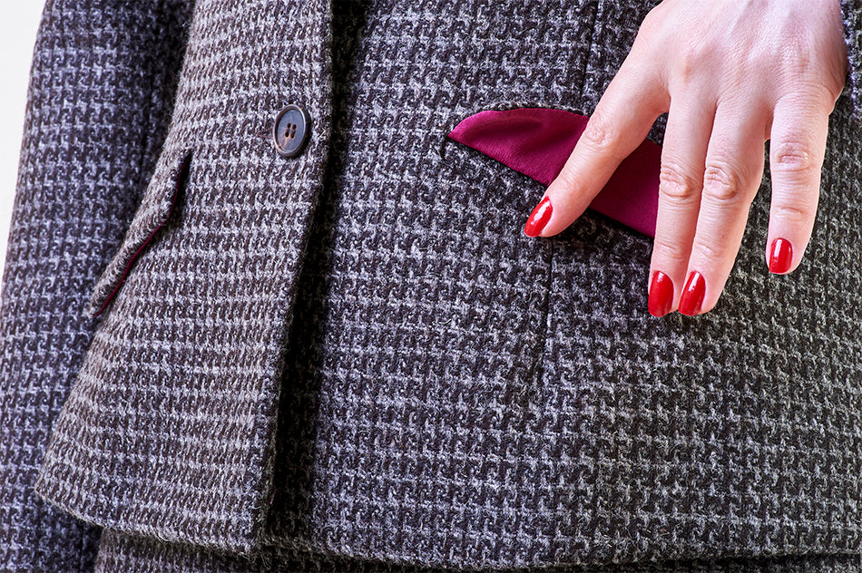 Detailed silver keystone tweed weave with horn buttons and vibrant fuchsia silk lining.