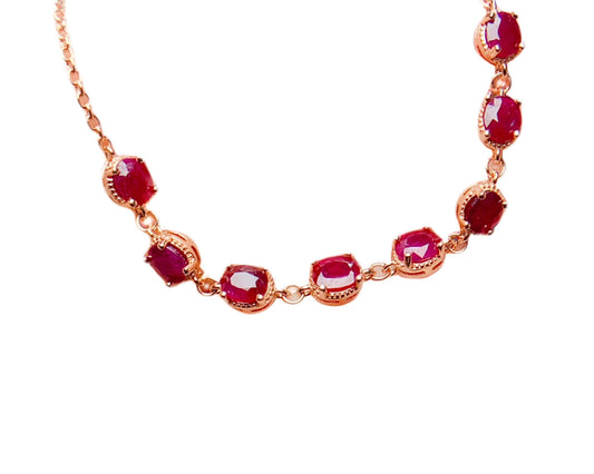 Natural ruby triangle-cut bracelet on white background, 18K rose gold plated 925 silver, ethical fine jewellery.