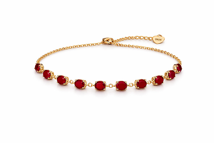 Close-up of ruby red gemstone tennis bracelet crafted in gold plated 925 sterling silver, elegant fine jewellery piece