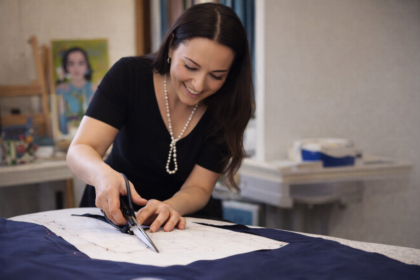 Fashion designer Maria Ruseva cutting fabric in her London atelier during an advanced garment repair and sewing workshop.