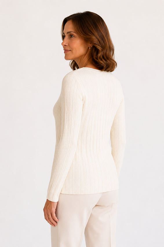 Back three-quarter view of cream ribbed knit top with elegant fitted shape.