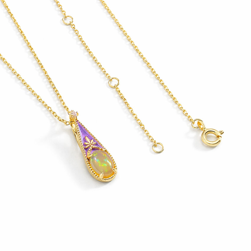 Victorian inspired opal pendant necklace in gold vermeil plated 925 sterling silver, delicate enamel teardrop design photographed at angle on clean white background

