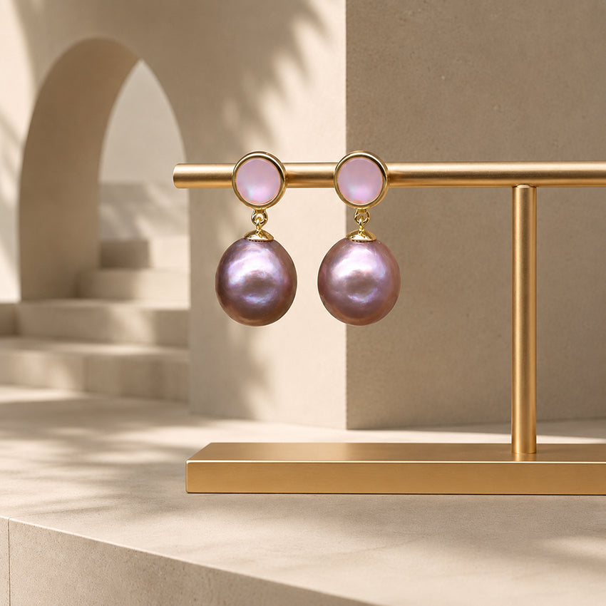 Luxury baroque freshwater pearl drop earrings with gold-plated setting displayed against a modern architectural backdrop, elegant handcrafted statement jewellery for women