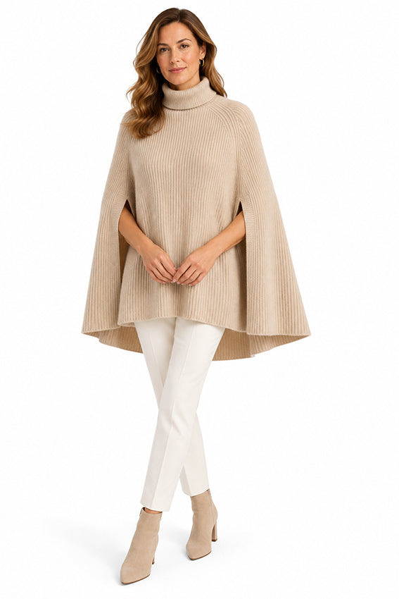 Luxury organic cashmere cape for women in natural beige, featuring a heavyweight ribbed knit, high neck and elegant A-line silhouette.