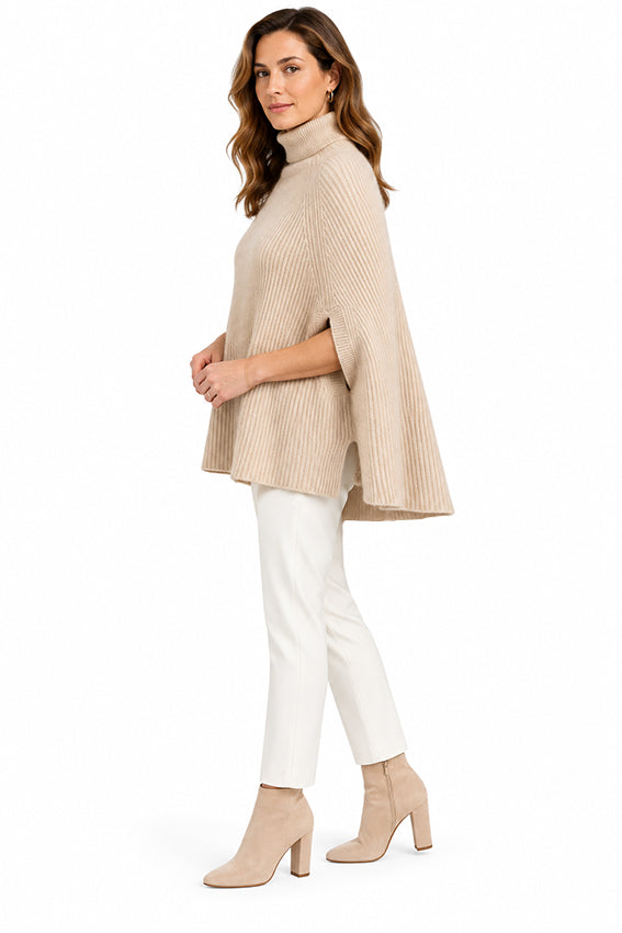 Side view of luxury organic cashmere cape for women in natural beige, showing the heavyweight ribbed texture, arm slit and flowing silhouette.