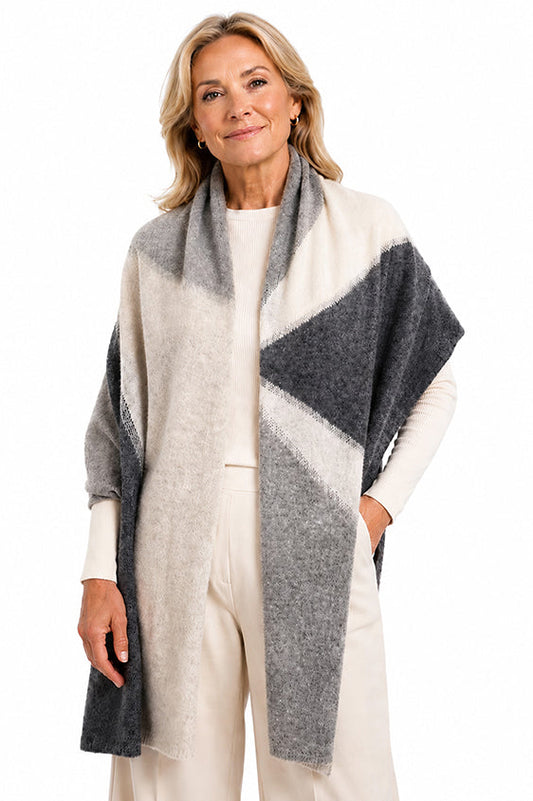 Elegant woman wearing Moda de la Maria 100% pure cashmere colour-block pashmina scarf in grey, cream and charcoal on a white background.