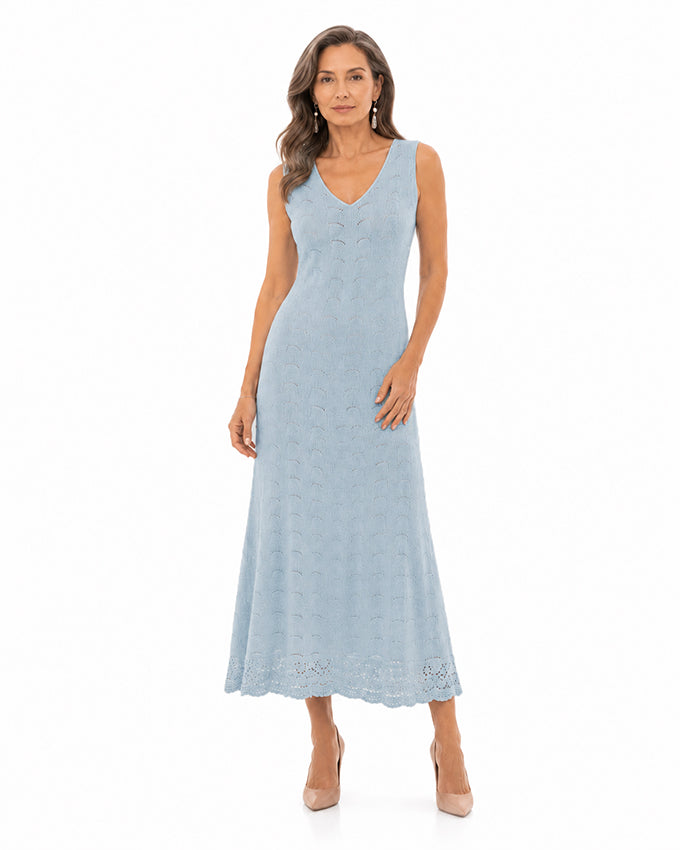 Mature model wearing a light blue cashmere knit midi dress by Moda de la Maria on a white background with elegant luxury styling