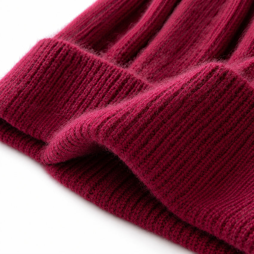 Close-up of dark burgundy pure cashmere beanie showing the soft ribbed knit texture 