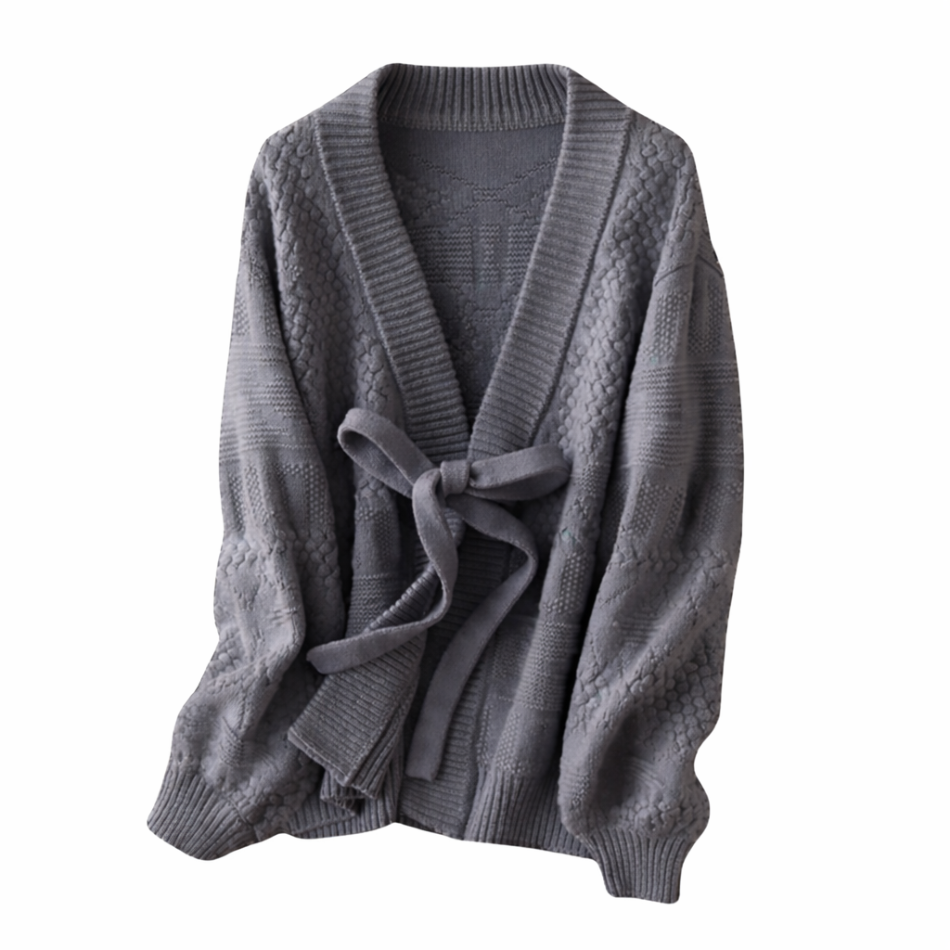 Women's grey cable knit cashmere cardigan with belt by Moda de la Maria on wooden hanger against white background