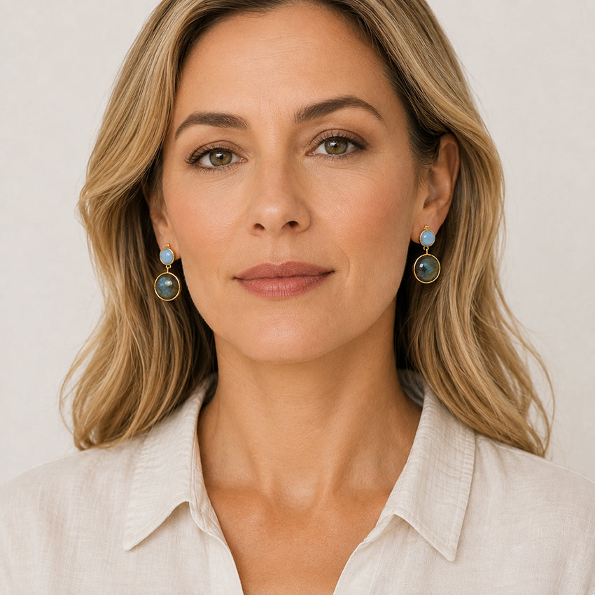 Woman wearing natural aquamarine and labradorite drop earrings handcrafted in 18ct gold-plated 925 sterling silver by Moda de la Maria.