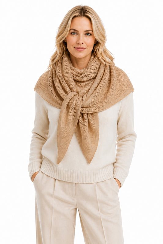 Luxury women's 100% pure cashmere beige knitted triangle scarf by Moda de la Maria, beautifully styled on a blonde model. Soft handcrafted premium cashmere scarf with an elegant lightweight knit, timeless British luxury fashion and effortless year-round layering on a pure white background.