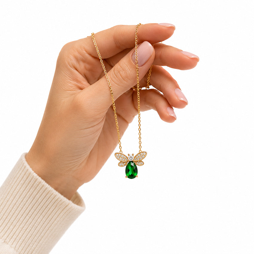 Elegant Natural Green Diopside Bee Pendant Necklace in sterling silver with 18ct gold vermeil, displayed by hand to showcase its fine craftsmanship.