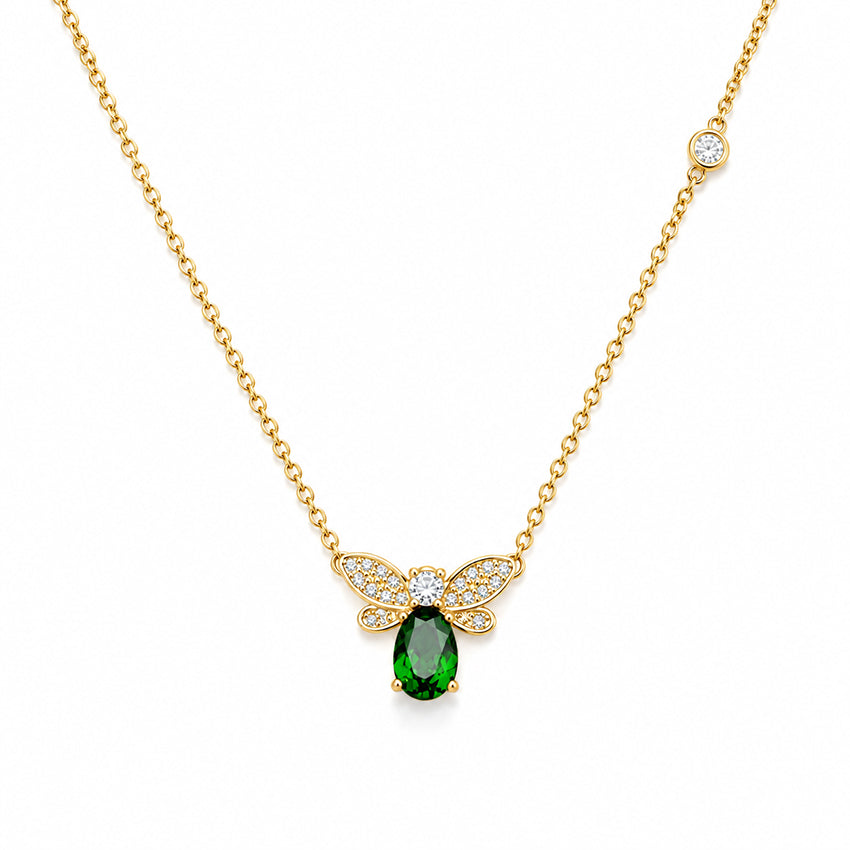Elegant Natural Green Diopside Bee Pendant Necklace in sterling silver with an 18ct gold vermeil finish, featuring pavé cubic zirconia wings, a brilliant green diopside gemstone and a bezel-set side zirconia by Moda de la Maria.