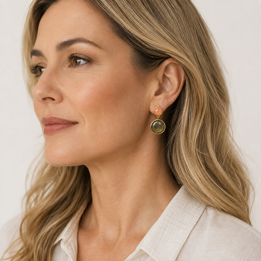 Woman wearing natural labradorite and pink gemstone drop earrings handcrafted in 18ct gold-plated 925 sterling silver by Moda de la Maria.
