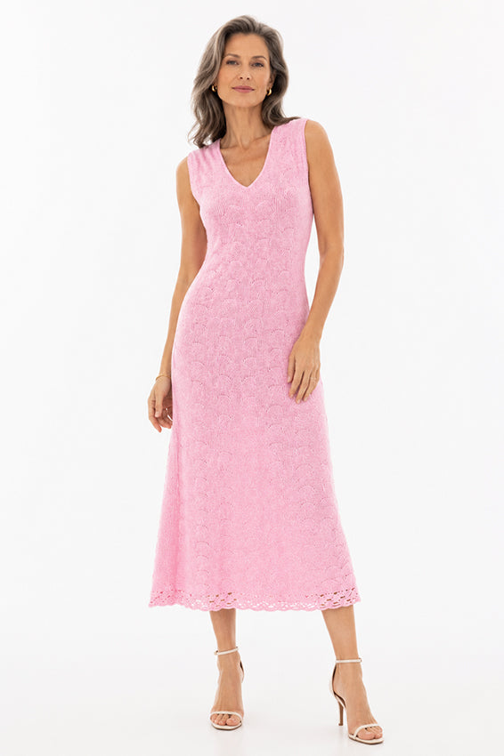 Elegant mature model wearing a soft pink cashmere knit midi dress by Moda de la Maria on a pure white background with timeless luxury womenswear styling