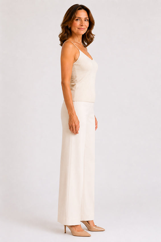 Side profile view of a luxury organic cashmere camisole in natural ivory showing silhouette and fit
