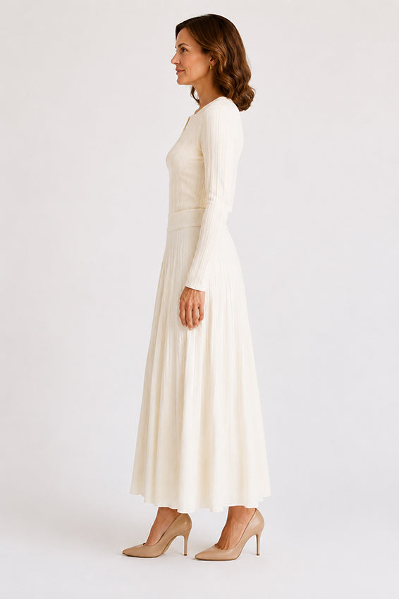 Side profile of an ivory organic cashmere knitted skirt on a woman over 40, highlighting the flowing shape and elegant movement.