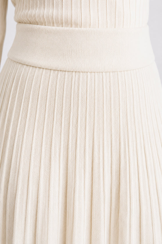 Close-up of the organic cashmere ivory knitted skirt waistband, showing the refined knit construction and luxurious texture.