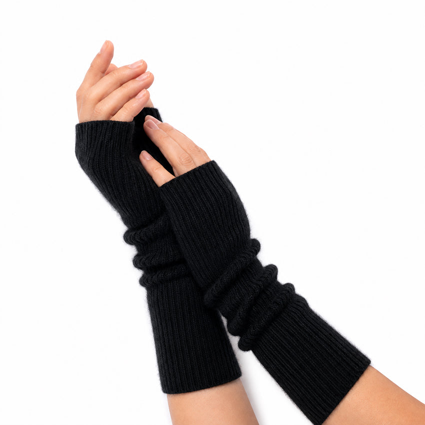 Woman wearing Black pure cashmere fingerless gloves with an elegant long ribbed cashmere design.
