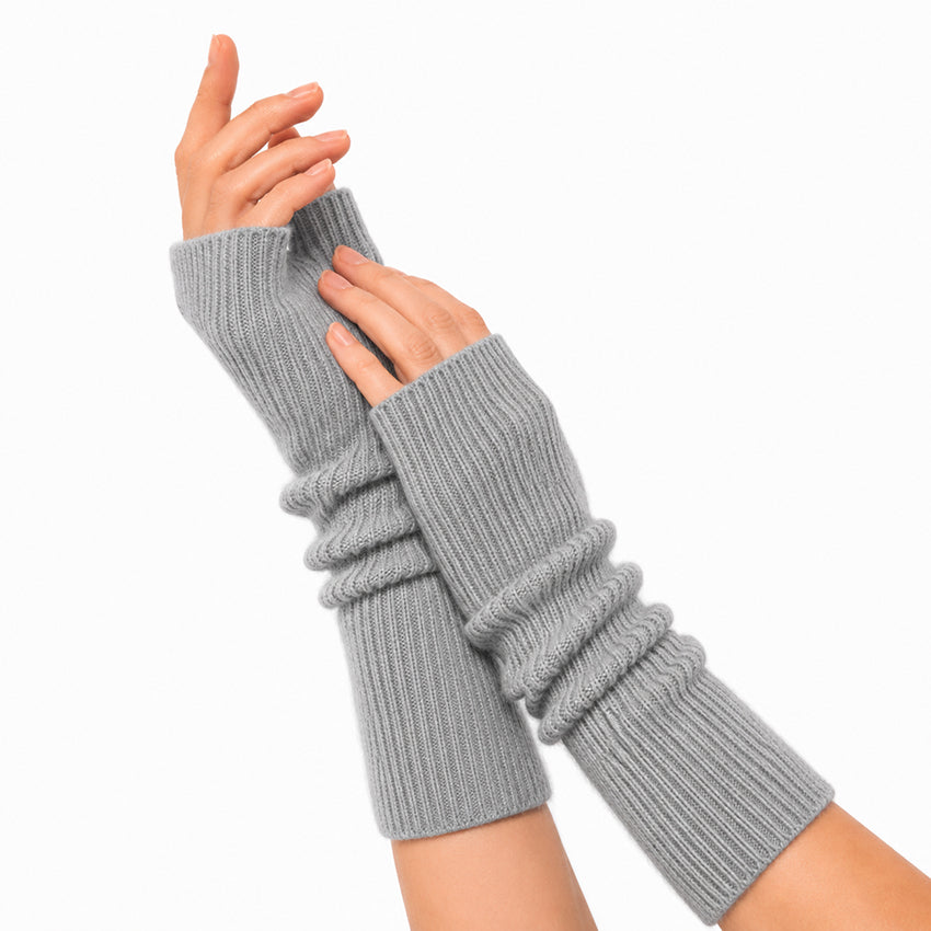Woman wearing Grey pure cashmere fingerless gloves with a luxurious soft ribbed knit finish.