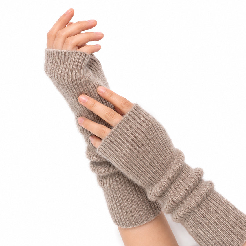 Woman wearing Oatmeal pure cashmere fingerless gloves, showing the soft ribbed cashmere texture and long fit.