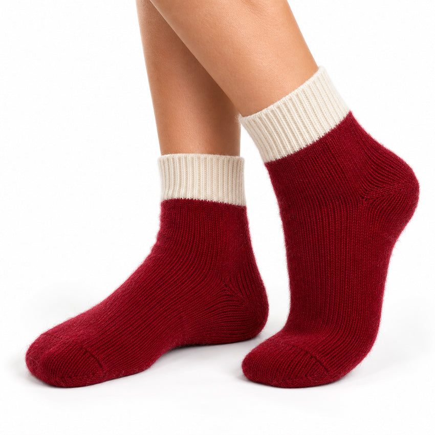 Women's deep red pure cashmere ankle socks with ivory cream ribbed cuffs by Moda de la Maria, shown worn on the feet.