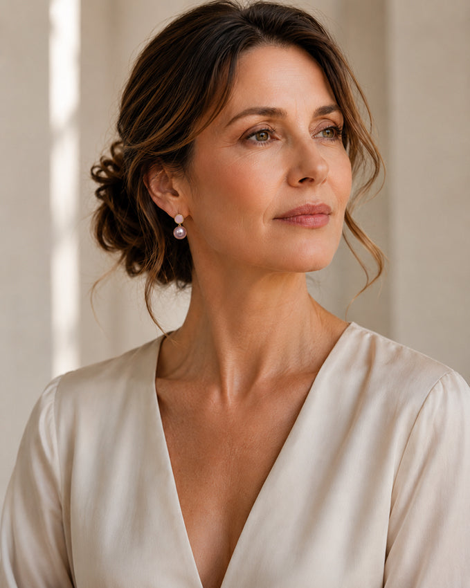 Elegant woman aged 40 plus wearing baroque freshwater pearl drop earrings with gold-plated setting, handcrafted luxury pearl jewellery designed for timeless sophistication and modern elegance